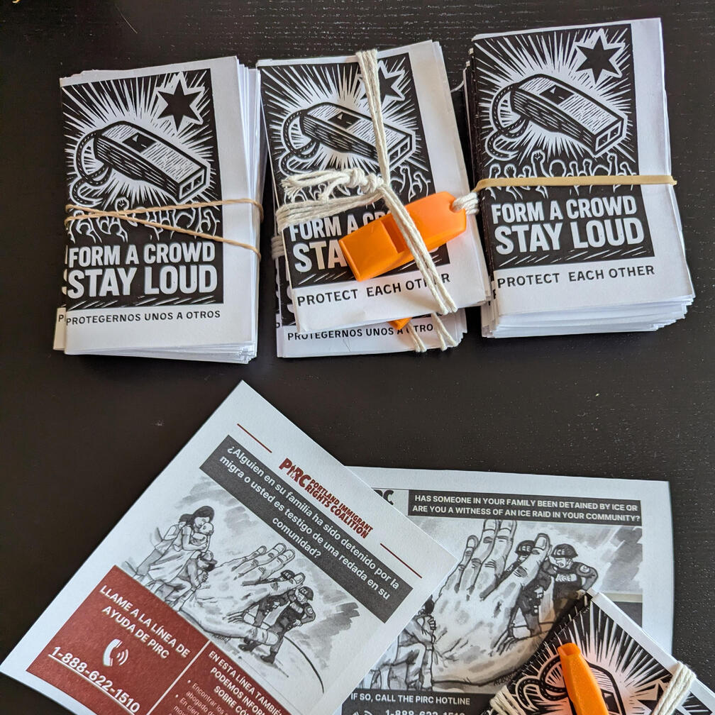 Migra Whistle Image of whistle kits including "Form a Crowd, Stay Loud" zine and PIRC (Oregon) hotline insert. A whistle on string is used to bundle each kit together.